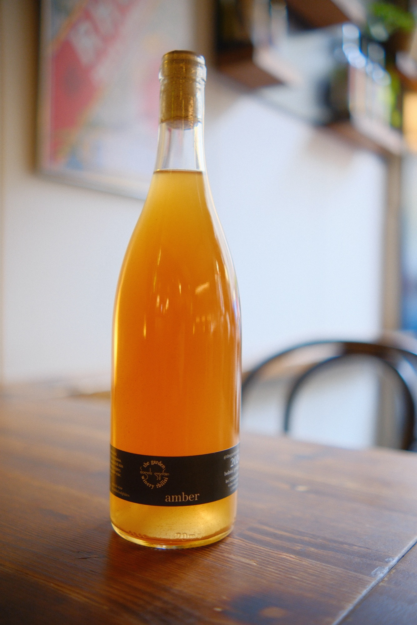 Amber Rkatsiteli 2024 — clear bottle, dark label reading amber, deep golden wine